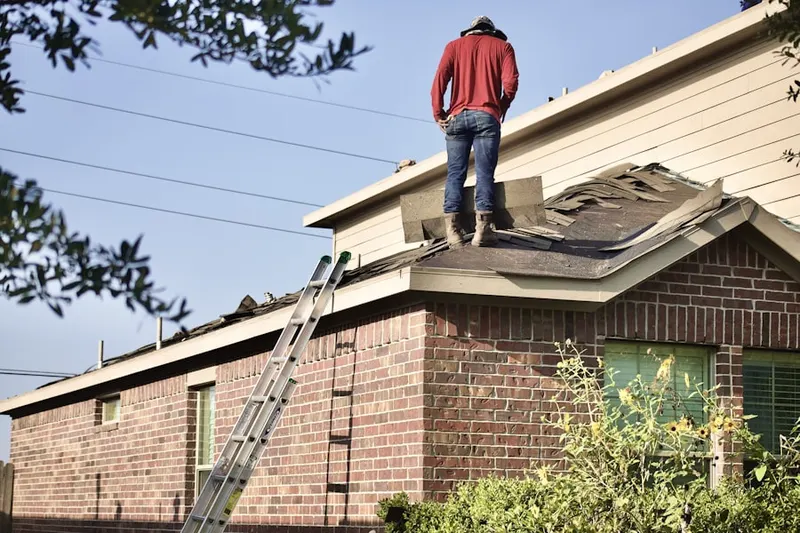 Professional roofer working on a residential roof in Meridian Heights